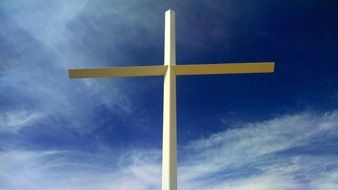 wooden cross on blue sky background