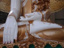 hands of buddha statue close up