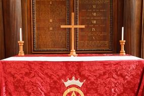 candles and a cross on the altar of the Catholic Church