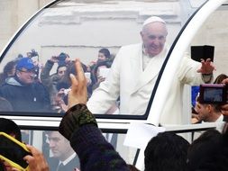 Pope francis among people in a special car