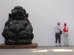 People near the sculpture of Buddha