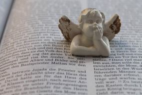 The figure of an angel on a sacred book