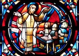 Church stained glass with the image of Christ, which teaches children