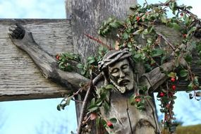 wooden crucifix in the thickets of plants