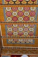 colorful floral painting on buddhist temple ceiling