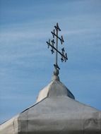 cross on the roof of the church against the sky