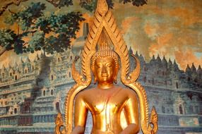Golden Buddha statue and colorful wall in Bali, Indonesia