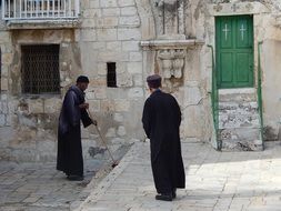 Coptic priest near a Christian near the temple