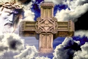 painted wooden cross against the sky and the head of Jesus