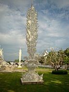 white temple on green grass in Thailand