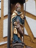 statue of the bishop on the facade of the building