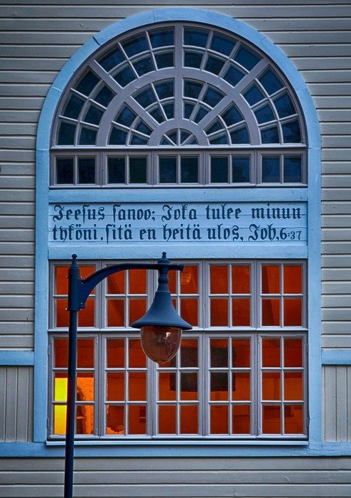 lantern on the background of the church window in Finland