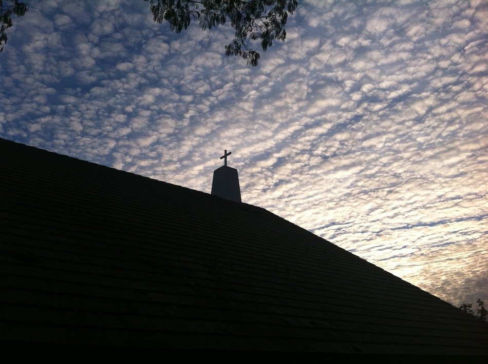 Christian cross silhouette in the sky