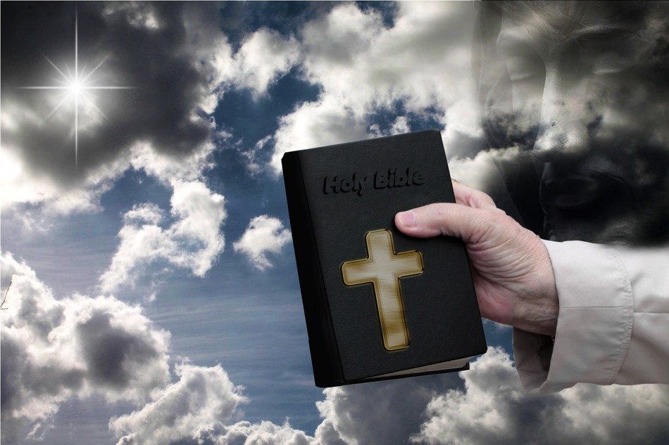 bible in hand at sky
