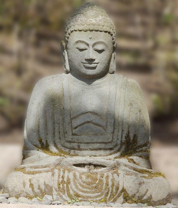 sculpture of a buddha in light and shadow