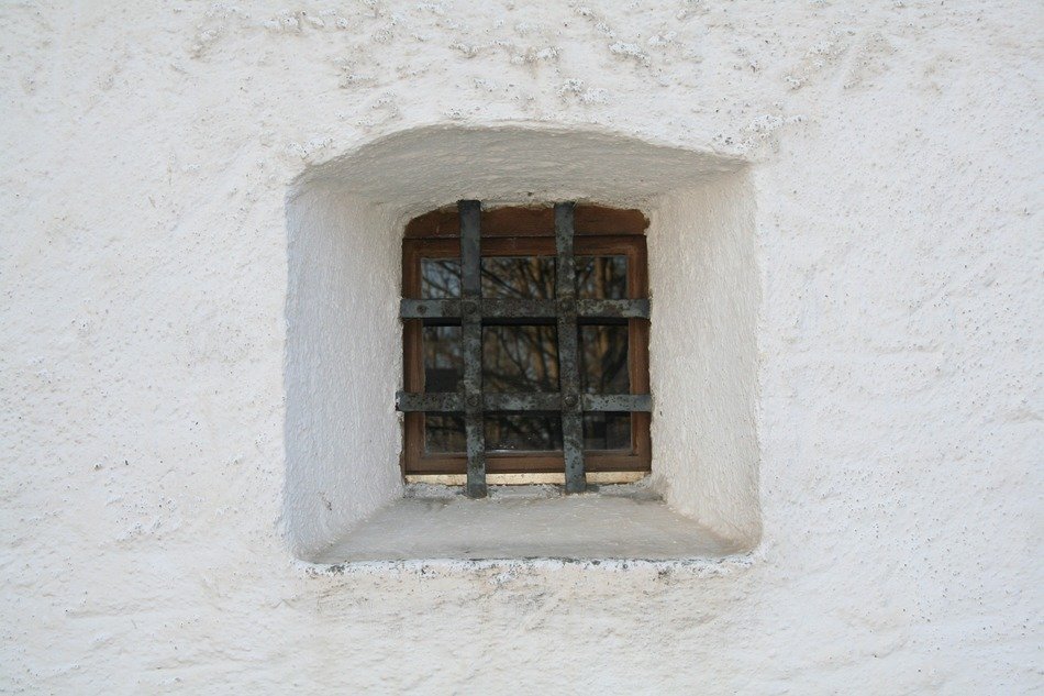 window with bars on the wall in the church