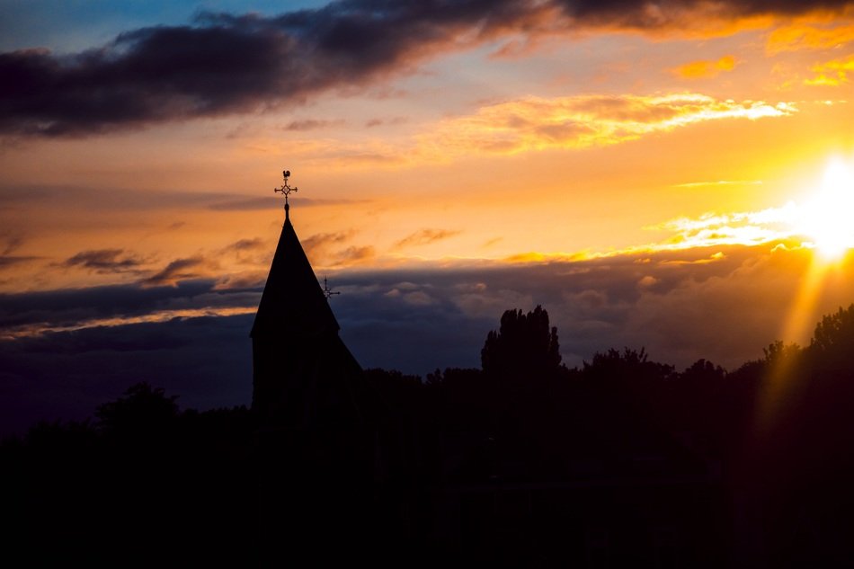 tower of a church at sunset in geldermalsen