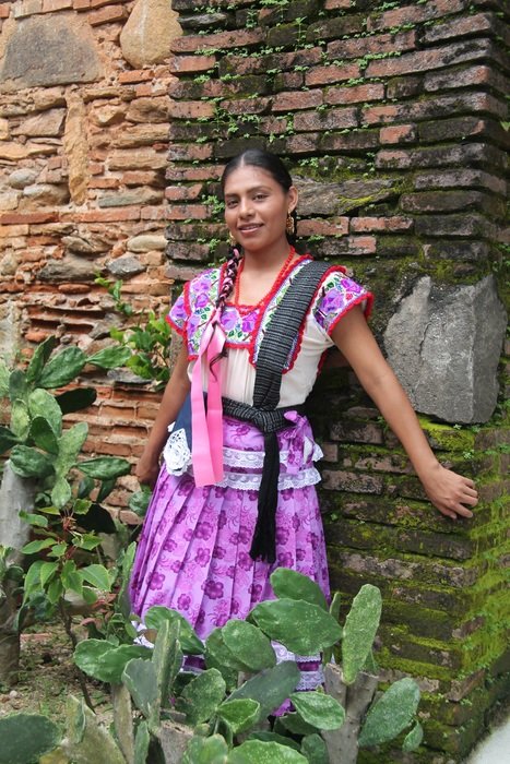 mexican woman stands near cacti
