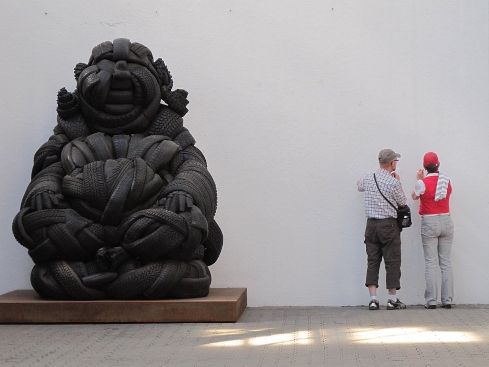 People near the sculpture of Buddha