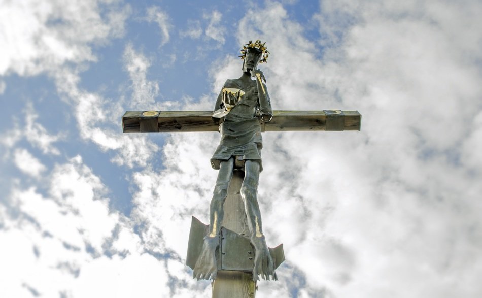 Jesus on the cross against the blue sky