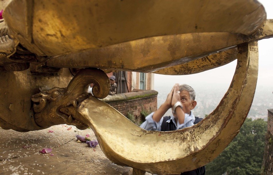 man praying in the temple of Nepal