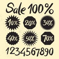 Sale labels with ink letters on the sandy background
