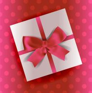 white gift with pink ribbon and bow