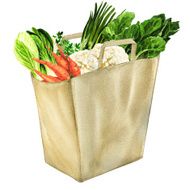 vegetables in white grocery bag isolated