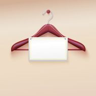 Clothes hanger with tag isolated on cream background