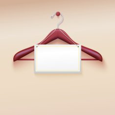 Clothes hanger with tag isolated on cream background