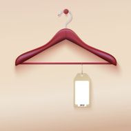 Clothes hanger with tag isolated on cream background N2