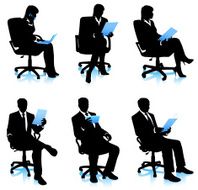 Businesswomen and businessmen in chairs