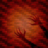 Shadow of two hand on a brick wall