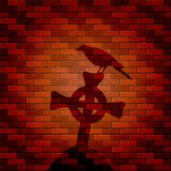 Shadow of raven and cross on a brick wall