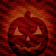 Shadow of Halloween pumpkin on a brick wall
