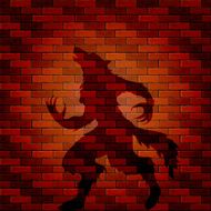 Shadow of werewolf on a brick wall