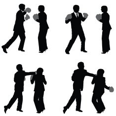 Businessman boxing with businesswoman