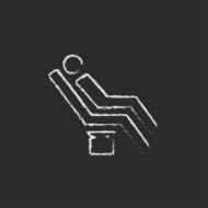 Man sitting on a dental chair icon drawn in chalk N2