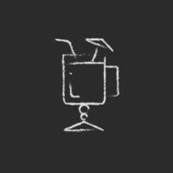 Glass with drinking straw and umbrella icon drawn in chalk