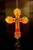 stained glass window with a cross in the church