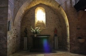 sunlight bursting through arched window in church