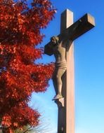 cross jesus and red foliage