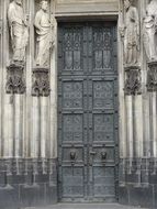 big door to the building with statues