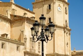 lantern near a large church on a sunny day