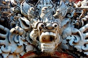 lion on the wall of a temple in bali