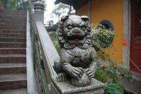 stone lion in asian style on the stairs