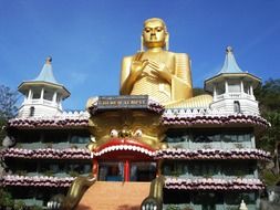 golden buddha statue on the roof of the temple on Sri Lanka