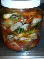 kimchi with oysters in a jar closeup