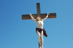 statue of jesus on the cross against the blue sky
