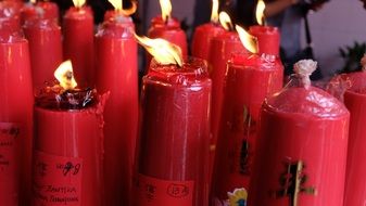 burning red candles with chinese symbols